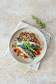 Mackerel on a bed of vegetables with buckwheat