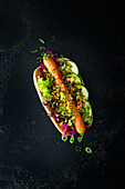 Hotdogs with red cabbage, gherkins and fried onions