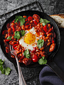 Spanish bean pan with chorizo and egg
