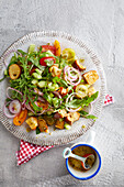 Brezanella salad with rocket, cucumber and cherry tomatoes