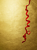 Red velvet ribbon on a golden background