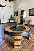 A table made from a wine cask with a decorative design made of wine bottle corks. Bodega Nanni, Cafayete, Argentina.