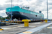 Cargo ship passing through Miraflores Locks in the Panama Canal.