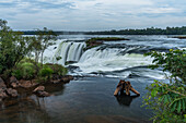 The water of the Iguazu River falls over the precipice of the Garganta del Diablo or the Devil's Throat Waterfall in Iguazu Falls National Park in both Argentina and Brazil. Both parks are UNESCO World Heritage Sites.