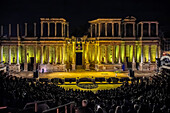 Merida, Spain, Aug 15 2024, A vibrant night performance at the historic Roman Theatre in Merida, Spain, with a full crowd gathered to enjoy the spectacle against the illuminated backdrop.