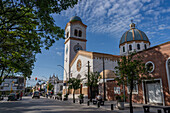 The exterior of the Church of Our Lady of the Rosary with its single bell tower with a clock. Monteros, Argentina.