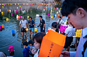 Press at work, in front of Atomic Bomb Dome with floating lamps on Motoyasu-gawa River during Peace Memorial Ceremony every August 6 in Hiroshima, Japan