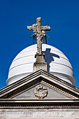 A cross on an elaborate tomb or mausoleum in the Recoleta Cemetery, Buenos Aires, Argentina.