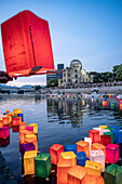 People float lanterns on the river, in front of Atomic Bomb Dome with floating lamps on Motoyasu-gawa River during Peace Memorial Ceremony every August 6 in Hiroshima, Japan