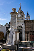 Tomb of General Miguel Etanislao Soler, who fought in the Argentine War of Independence. Recoleta Cemetery, Buenos Aires, Argentina. Behind is the bell tower of the Basilica de Nuestra Senora del Pilar.