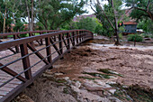 Flash flooding overflowing the banks of Mill Creek after a summer rain storm in Moab, Utah.