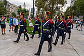 The military honor guard marching from the tomb of San Martin in the Cathedral to the Casa Rosada in Buenos Aires, Argentina. The soldiers are members of the Ayacucho Squadron of the Regiment of Horse Grenadiers and march with a low goosestep.