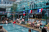 Clients refresh by the pool at Manifesto Market, a must-visit cultural experience in the heart of Prague with pop-up design retail experience bars and high-quality street food.