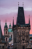 View of city skyline at sunset from Charles Bridge in Prague