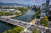 Skyline, in foreground Peace Bridge, Motoyasu river and Peace Memorial Park at left, Hiroshima, Japan