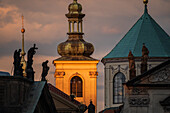 View of city skyline at sunset from Charles Bridge in Prague