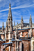 The stunning dome of the Royal Chapel showcases intricate architectural details against a clear blue sky in Seville, Spain.