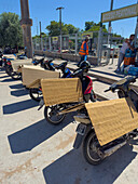 Folded cardboard protects the seats of parked motorcycles outside a shopping center in Tartagal, Argentina.