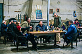 Pilas, Spain, Dec 20 2016, Group of men socializing and enjoying drinks in an old tavern setting in Pilas, Sevilla, Spain. Rustic ambiance reflects local culture and camaraderie.