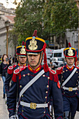 The military honor guard marching from the tomb of San Martin in the Cathedral to the Casa Rosada in Buenos Aires, Argentina. The soldiers are members of the Ayacucho Squadron of the Regiment of Horse Grenadiers.