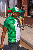 An indigenous man plays the siku panpipes plays for a religious procession in front of the church in Tilcara, Argentina.