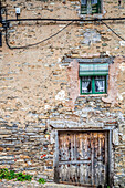 Discover the rustic beauty of weathered stone houses and quaint windows in Yanguas, Soria, showcasing charming historic architecture.