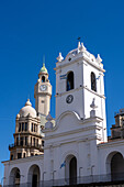 Cabildo with the clock tower of the Legislative Palace of the Autonomous City of Buenos Aires, Argentina behind. The Cabildo was the town hall or seat of government in colonial times.