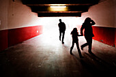 Fans exit a modern football stadium in Seville, flowing through the vomitorium towards the excitement of the match outside.