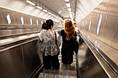 People using Prague Metro electric stairs