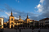 Burgo de Osma, Spain, Aug 12 2009, People gather in the lively Plaza Mayor of El Burgo de Osma as the sun sets, highlighting the historic architecture of Soria, Spain.