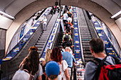 People using Prague Metro electric stairs