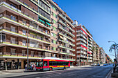 Seville, Spain, July 17 2009, Seville, Spain, July 17 2009, Buses travel along Avenida de la Republica Argentina, showcasing urban life in the Los Remedios district of Seville on a sunny day.