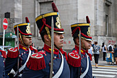 The military honor guard marching from the tomb of San Martin in the Cathedral to the Casa Rosada in Buenos Aires, Argentina. The soldiers are members of the Ayacucho Squadron of the Regiment of Horse Grenadiers.