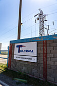 Sign for the Transnoa hydroelectric power generating station on the Rio Hondo Dam at Termas de Rio Hondo, Argentina.