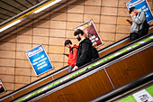 People using Prague Metro electric stairs