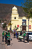 A band of drums and siku panpipes prepares for a religious procession in front of the church in Tilcara, Argentina.