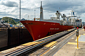 Cargo ship passing through Miraflores Locks in the Panama Canal.