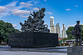 The statue of Juan Azurduy in the Plaza de Correo in front of the Libertad Palace in San Nicolas, Buenos Aires, Argentina. The modern skyline of Puerto Madero is behind.