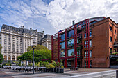 & A restaurent in a renovated warehouse in Puerto Madero, Buenos Aires, Argentina. Behind is the Libertador Building housing the Ministry of Defense.