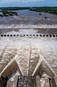 Plumes of water jet from the spillway of the Rio Hondo Dam at Termas de Rio Hondo in Argentina. Downriver is the Tara Inti Natural Reserve, including the small islands.