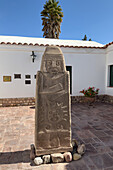 A carved bas relief monolith in the courtyard of the Dr. Eduardo Casanova Archeology Museum in Tilcara, Argentina.