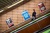 People using Prague Metro electric stairs