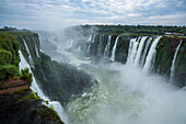 Mist obscures the Iguazu River below the Garganta del Diablo or the Devil's Throat Waterfall in Iguazu Falls National Park in both Argentina and Brazil. Both parks are UNESCO World Heritage Sites. The at left is in Argentina with Brazil across the river .