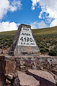 A stone marker at the crest of the Cuesta de Lipan on National Route 52 between Purmamarca and Salinas Grande, Argentina. 4,170 meters or 13,681 feet above sea level.