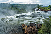 The Iguazu River flowing over the precipice of the San Martin Waterfall in Iguazu Falls National Park in Argentina. Salto Escondido or the Hidden Waterfall is just visible as well. A UNESCO World Heritage Site.