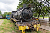 An old steam locomotive engine on display in the Paseo Estacion Park in San Jose de Metan, Argentina.