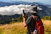 Hiker using his smartphone in the mountains of Sierra Nevada de Santa Marta, Colombia