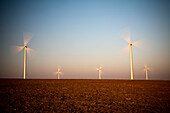 Windmills stand tall under the dusky sky of Sanlucar de Barrameda, generating clean energy for the town.