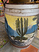 Painted wine barrel in the courtyard of the Museo de la Vid y el Vino or Museum of the Vine and the Wine in Cafayate, Argentina. The painting has a wine-making motif.