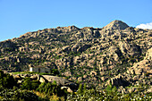 The chapel of Peña Sacra and the mountain of La Pedriza in the town of Manzanares el Real, Community of Madrid.